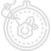 A simple line drawing of embroidery showing a needle stitching a floral pattern in a circular hoop.